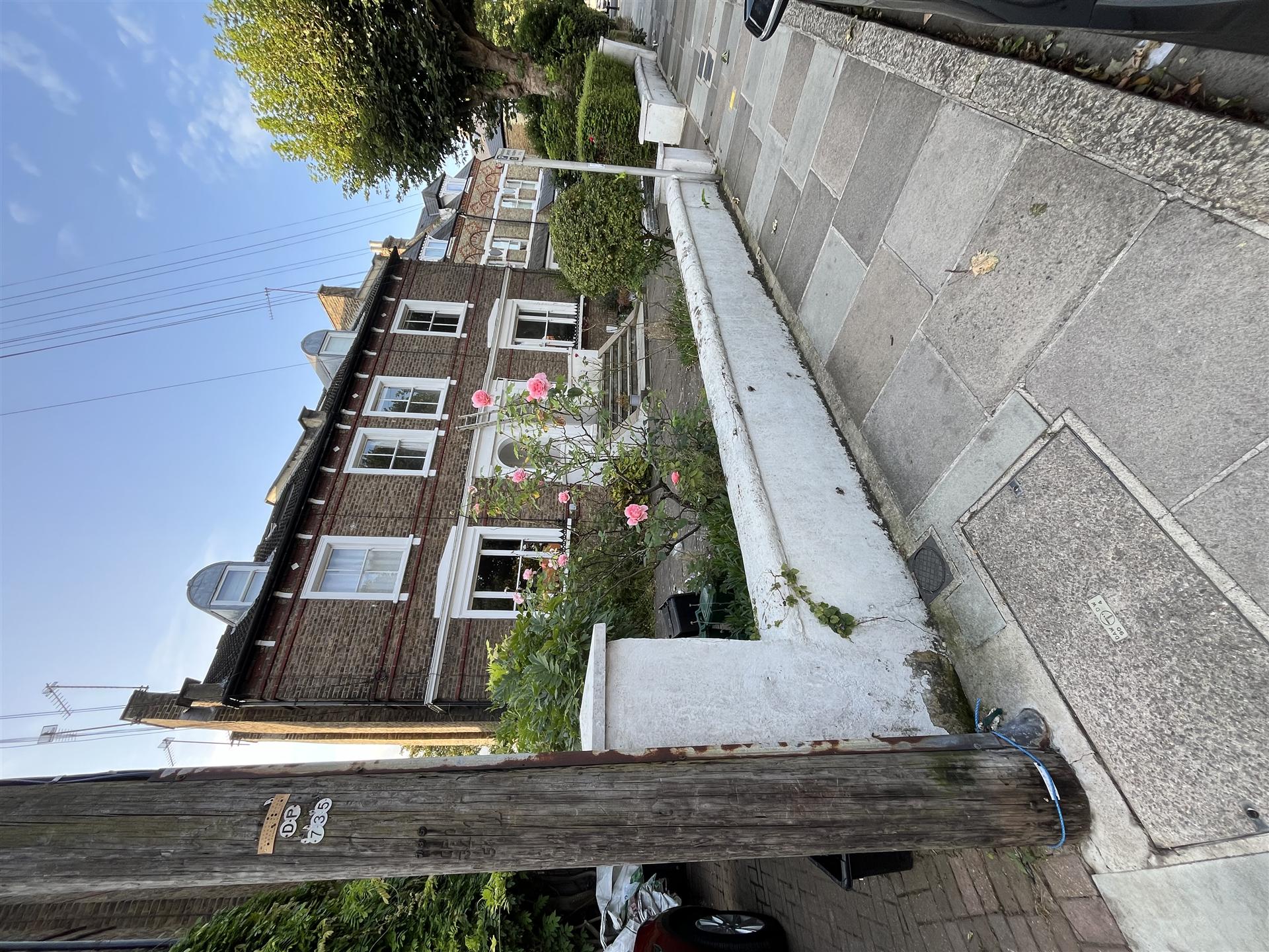 Before, brick terrace house with tired white paintwork, Essex